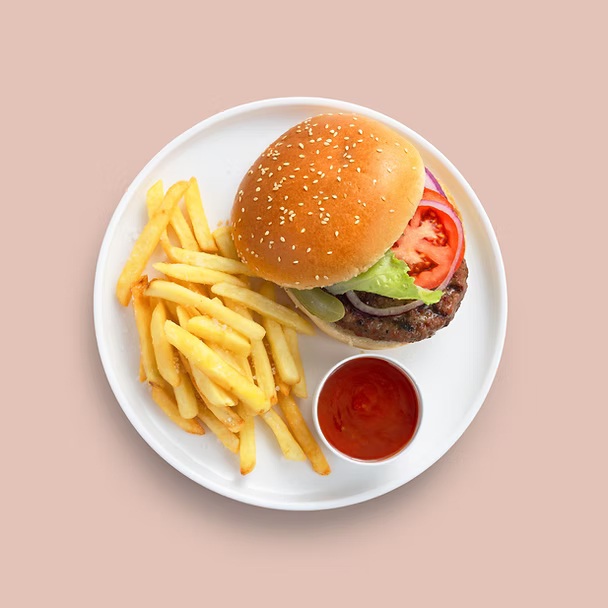 Classic burger with lettuce, pickles, tomatoes, and fries