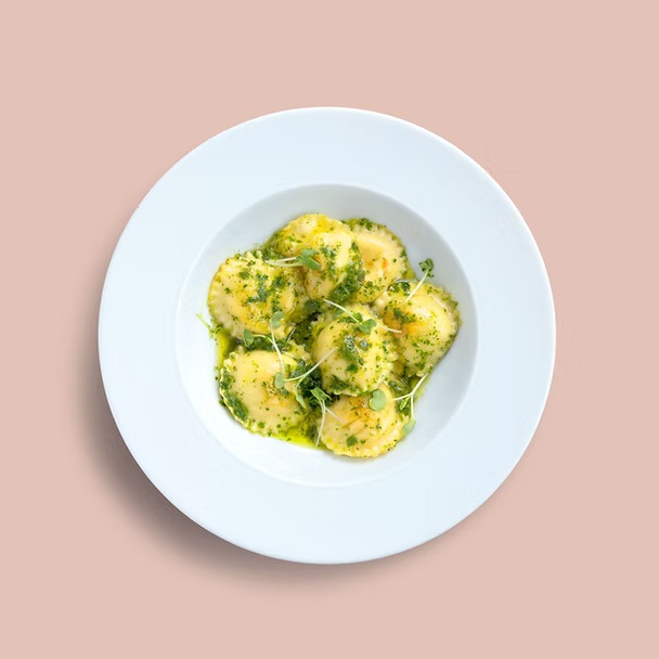 Hand-made ravioli filled with a blend of cheeses in a basil pesto sauce