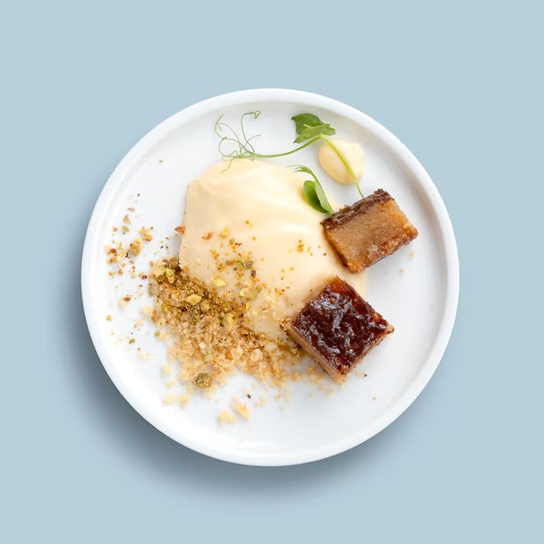 Sticky date pudding with vanilla ice cream, toffee sauce & a peanut crumble